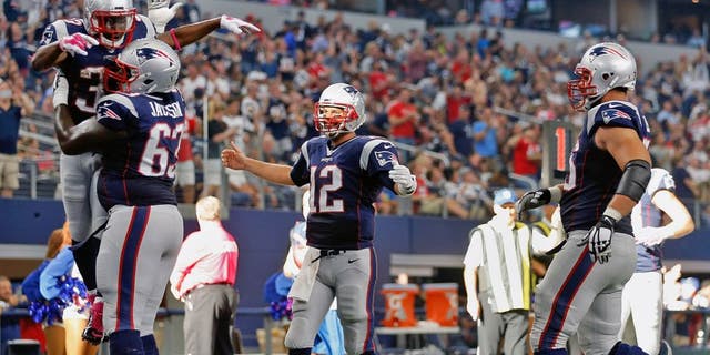 ARLINGTON, TX - OCTOBER 11: Running back Dion Lewis #33 of the New England Patriots is lifted in the air by offensive guard Tre Jackson #63 after scoring on a ten yard touchdown reception from quarterback Tom Brady #12 during the second half of the NFL game against the Dallas Cowboys at AT&T Stadium on October 11, 2015 in Arlington, Texas. (Photo by Christian Petersen/Getty Images)
