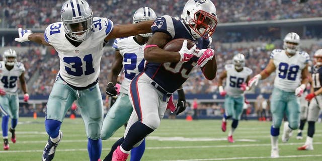 ARLINGTON, TX - OCTOBER 11: Running back Dion Lewis #33 of the New England Patriots carries the ball as cornerback Byron Jones #31 of the Dallas Cowboys tries to make the tackle during the first half of the NFL game at AT&T Stadium on October 11, 2015 in Arlington, Texas. (Photo by Christian Petersen/Getty Images)