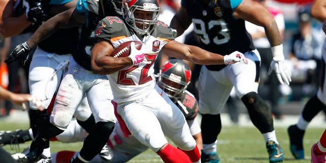Oct 11, 2015; Tampa, FL, USA; Tampa Bay Buccaneers running back Doug Martin (22) runs for a first down during past Jacksonville Jaguars strong safety Johnathan Cyprien (37) the second quarter of an NFL football game at Raymond James Stadium. Mandatory Credit: Reinhold Matay-USA TODAY Sports