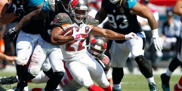 Oct 11, 2015; Tampa, FL, USA; Tampa Bay Buccaneers running back Doug Martin (22) runs for a first down during past Jacksonville Jaguars strong safety Johnathan Cyprien (37) the second quarter of an NFL football game at Raymond James Stadium. Mandatory Credit: Reinhold Matay-USA TODAY Sports