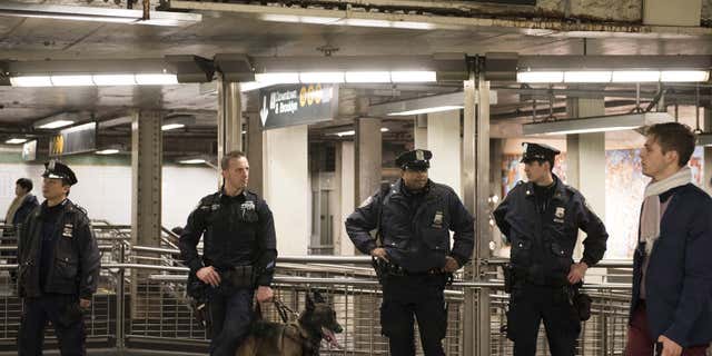 Dec. 31, 2015: New York Police Department officers stand guard inside the Times Square subway station ahead of New Year's Eve celebrations in New York.