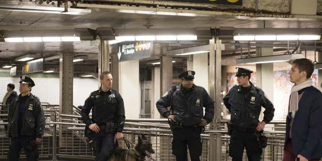 Dec. 31, 2015: New York Police Department officers stand guard inside the Times Square subway station ahead of New Year's Eve celebrations in New York.