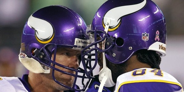 Oct. 11: Minnesota Viking wide receiver Randy Moss (R) and quarterback Brett Favre butt heads together on the bench before their NFL football game against the New York Jets in East Rutherford, New Jersey.
