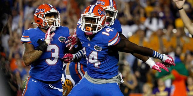 Oct 11, 2014; Gainesville, FL, USA; Florida Gators defensive lineman Alex McCalister (14) reacts after he sacks LSU Tigers quarterback Anthony Jennings (10) during the first quarter at Ben Hill Griffin Stadium. Mandatory Credit: Kim Klement-USA TODAY Sports