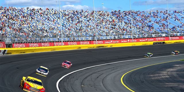 CHARLOTTE, NC - OCTOBER 11: Joey Logano, driver of the #22 Shell Pennzoil Ford, leads a pack of cars during the NASCAR Sprint Cup Series Bank of America 500 at Charlotte Motor Speedway on October 11, 2015 in Charlotte, North Carolina. (Photo by Robert Laberge/NASCAR via Getty Images)