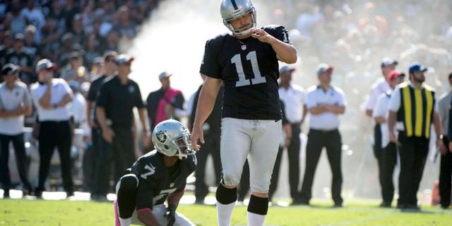 October 11, 2015; Oakland, CA, USA; Oakland Raiders kicker Sebastian Janikowski (11) reacts after missing a field goal from the hold by punter Marquette King (7) during the fourth quarter against the Denver Broncos at O.co Coliseum. The Raiders defeated the Broncos 16-10. Mandatory Credit: Kyle Terada-USA TODAY Sports