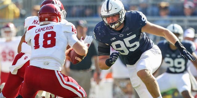 Oct 10, 2015; University Park, PA, USA; Penn State Nittany Lions defensive end Carl Nassib (95) pressures Indiana Hoosiers quarterback Danny Cameron (18) during the fourth quarter at Beaver Stadium. Penn State defeated Indiana 29-7. Mandatory Credit: Matthew O'Haren-USA TODAY Sports