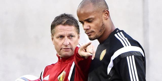 Belgium's Coach Marc Wilmots (L) and defender Vincent Kompany attend a training session at the Estadi Comunal in Andorra la Vella on October 10, 2015, on the eve of the Euro2016 qualifying group D football match Andorra against Belgium. AFP PHOTO / PASCAL PAVANI (Photo credit should read PASCAL PAVANI/AFP/Getty Images)