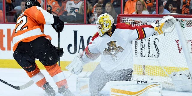 Oct 12, 2015; Philadelphia, PA, USA; Philadelphia Flyers left wing Michael Raffl (12) has his shot stopped by Florida Panthers goalie Roberto Luongo (1) during the second period at Wells Fargo Center. Mandatory Credit: Eric Hartline-USA TODAY Sports