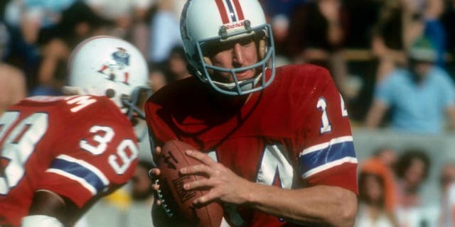 TAMPA BAY, FL - DECEMBER 12: Quarterback Steve Grogan #14 of the New England Patriots drops back to pass against the Tampa Bay Buccaneers during an NFL football game at Tampa Stadium December 12, 1976 in Tampa Bay, Florida. Grogan played for the Patriots from 1975-90. (Photo by Focus on Sport/Getty Images)