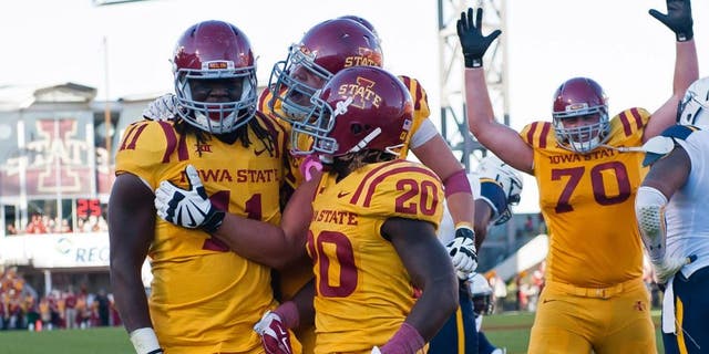 Oct 11, 2014; Ames, IA, USA; Iowa State Cyclones tight end E.J. Bibbs (11) celebrates with running back DeVondrick Nealy (20) and offensive lineman Daniel Burton (70) after scoring against the Toledo Rockets at Jack Trice Stadium. Iowa State defeated Toledo 37-30. Mandatory Credit: Steven Branscombe-USA TODAY Sports