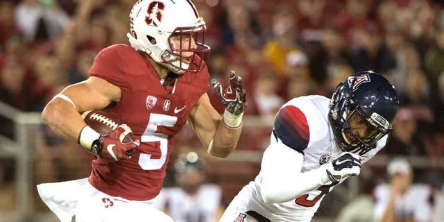 October 3, 2015; Stanford, CA, USA; Stanford Cardinal running back Christian McCaffrey (5) runs the football against Arizona Wildcats cornerback Cam Denson (3) during the first quarter at Stanford Stadium. Mandatory Credit: Kyle Terada-USA TODAY Sports