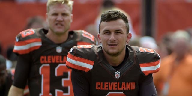 Sep 27, 2015; Cleveland, OH, USA; Cleveland Browns quarterbacks Johnny Manziel (2) and Josh McCown (13) stretch before a NFL game against the Oakland Raiders at FirstEnergy Stadium.