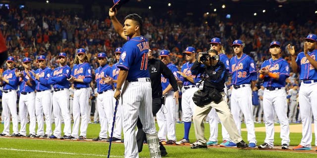 NEW YORK, NY - OCTOBER 12: An injured Ruben Tejada #11 of the New York Mets waves to the crowd prior to game three of the National League Division Series against the Los Angeles Dodgers at Citi Field on October 12, 2015 in New York City. (Photo by Elsa/Getty Images)