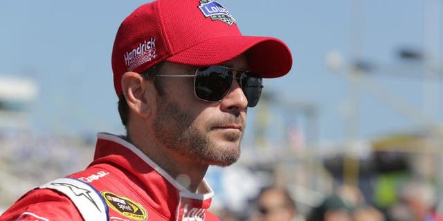 CHARLOTTE, NC - OCTOBER 11: Jimmie Johnson, driver of the #48 Lowe's Red Vest Chevrolet, stands on the grid during the NASCAR Sprint Cup Series Bank of America 500 at Charlotte Motor Speedway on October 11, 2015 in Charlotte, North Carolina. (Photo by Jerry Markland/Getty Images)