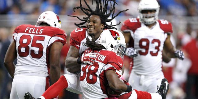 Oct 11, 2015; Detroit, MI, USA; Arizona Cardinals running back Andre Ellington (38) celebrates with running back Chris Johnson (23) after a touchdown during the fourth quarter against the Detroit Lions at Ford Field. Cardinals won 42-17. Mandatory Credit: Raj Mehta-USA TODAY Sports