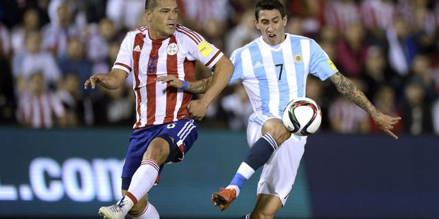 Paraguay's Miguel Angel Samudio (L) and Argentina's forward Angel Di Maria vie for the ball during their Russia 2018 FIFA World Cup South American Qualifiers football match, at the Defensores del Chaco stadium in Asuncion, on October 13, 2015. AFP PHOTO / JUAN MABROMATA (Photo credit should read JUAN MABROMATA/AFP/Getty Images)