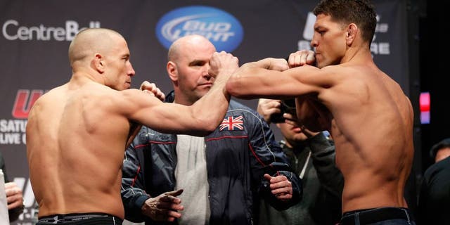 MONTREAL, QC - MARCH 15: Georges St-Pierre (L) and Nick Diaz (R) face off during the UFC 158 weigh-in at Bell Centre on March 15, 2013 in Montreal, Quebec, Canada. (Photo by Josh Hedges/Zuffa LLC/Zuffa LLC via Getty Images)