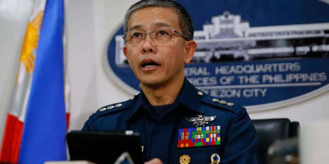 Oct. 14, 2015: Col. Restituto Padilla, spokesman of the Armed Forces of the Philippines, reads the military's reaction to the video purportedly showing for the first time two Canadians, a Norwegian and a Filipino woman who were abducted last month from a southern Philippines resort, demanding that government forces stop artillery fire and assaults, following a news conference.