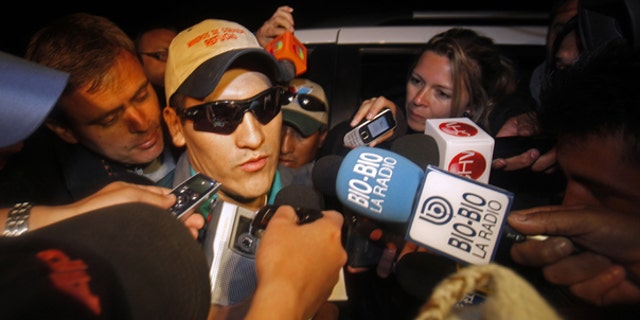 Oct. 14: Rescued miner Carlos Mamani, from Bolivia, is surrounded by the press as he arrives at his home in Copiapo, Chile.