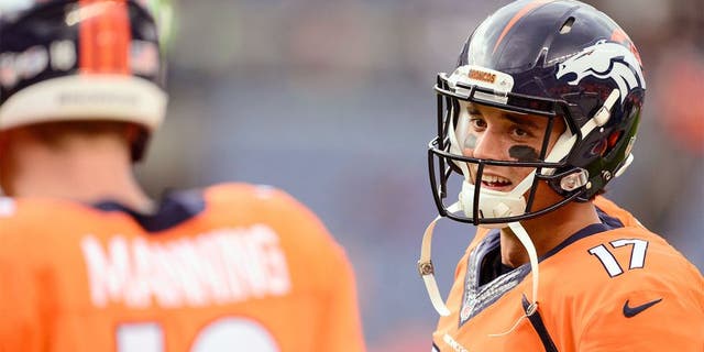 Sep 3, 2015; Denver, CO, USA; Denver Broncos quarterback Brock Osweiler (17) talks to quarterback Peyton Manning (18) before the preseason game against the Arizona Cardinals at Sports Authority Field at Mile High. Mandatory Credit: Ron Chenoy-USA TODAY Sports