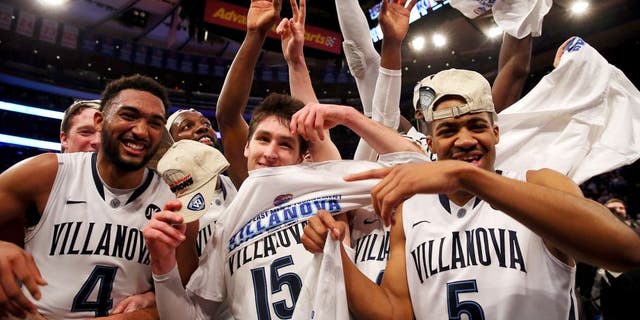 NEW YORK, NY - MARCH 14: Darrun Hilliard #4, Ryan Arcidiacono #15, and Phil Booth #5 of the Villanova Wildcats celebrate on the court after defeating the Xavier Musketeers 69-52 in the championship game of the Big East basketball tournament at Madison Square Garden on March 14, 2015 in New York City. (Photo by Elsa/Getty Images)