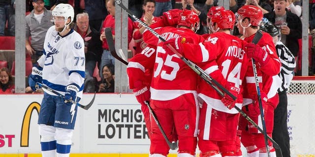 DETROIT, MI - OCTOBER 13: Gustav Nyquist #14 of the Detroit Red Wings celebrates his second period goal with teammates Niklas Kronwall #55, Gustav Nyquist #14, Henrik Zetterberg #40 and Dylan Larkin #71 during an NHL game against the Tampa Bay Lightning at Joe Louis Arena on October 13, 2015 in Detroit, Michigan. (Photo by Dave Reginek/NHLI via Getty Images)