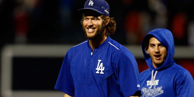 NEW YORK, NY - OCTOBER 13: Clayton Kershaw #22 of the Los Angeles Dodgers smiles after defeating the New York Mets in game four of the National League Division Series at Citi Field on October 13, 2015 in New York City. The Dodgers defeated the Mets with a score of 3 to 1. (Photo by Mike Stobe/Getty Images)