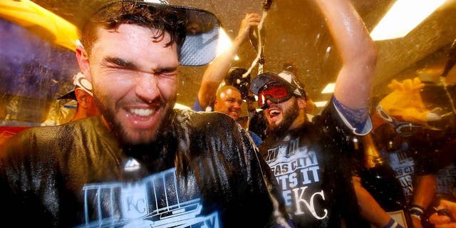 KANSAS CITY, MO - OCTOBER 14: Eric Hosmer #35 of the Kansas City Royals, left, celebrates with teammates in the clubhouse after defeating the Houston Astros 7-2 in game five of the American League Divison Series at Kauffman Stadium on October 14, 2015 in Kansas City, Missouri. (Photo by Jamie Squire/Getty Images)