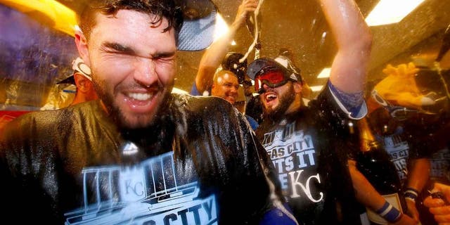 KANSAS CITY, MO - OCTOBER 14: Eric Hosmer #35 of the Kansas City Royals, left, celebrates with teammates in the clubhouse after defeating the Houston Astros 7-2 in game five of the American League Divison Series at Kauffman Stadium on October 14, 2015 in Kansas City, Missouri. (Photo by Jamie Squire/Getty Images)