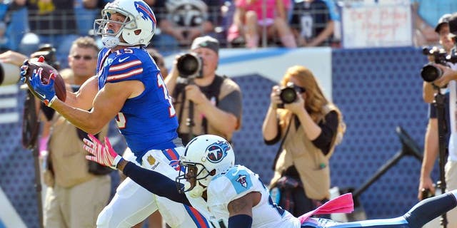 Oct 11, 2015; Nashville, TN, USA; Buffalo Bills wide receiver Chris Hogan (15) catches a pass against Tennessee Titans cornerback Coty Sensabaugh (24) to set up for the touchdown during the second half at Nissan Stadium. Buffalo won 14-13. Mandatory Credit: Jim Brown-USA TODAY Sports