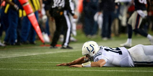 FOXBOROUGH, MA - JANUARY 18: Colts quarterback Andrew Luck gets hit by Patriots Chandler Jones, not pictured, in the fourth quarter at Gillette Stadium Sunday, January 18, 2015. AFC Championship Game between the New England Patriots and the Indianapolis Colts. (Photo by Jim Davis/The Boston Globe via Getty Images)