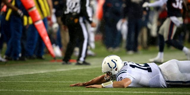 FOXBOROUGH, MA - JANUARY 18: Colts quarterback Andrew Luck gets hit by Patriots Chandler Jones, not pictured, in the fourth quarter at Gillette Stadium Sunday, January 18, 2015. AFC Championship Game between the New England Patriots and the Indianapolis Colts. (Photo by Jim Davis/The Boston Globe via Getty Images)