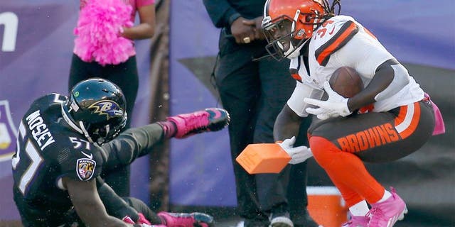 BALTIMORE, MD - OCTOBER 11: Running back Isaiah Crowell #34 of the Cleveland Browns reacts after scoring a second half touchdown in front of inside linebacker C.J. Mosley #57 of the Baltimore Ravens at M&T Bank Stadium on October 11, 2015 in Baltimore, Maryland. (Photo by Rob Carr/Getty Images)