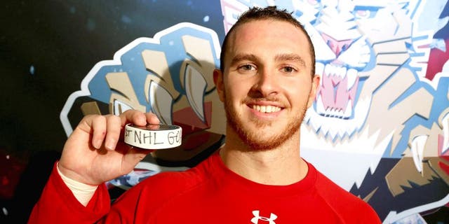 RALEIGH, NC - OCTOBER 13: Connor Brickley #86 of the Florida Panthers poses with the puck after scoring his first NHL goal following a game against the Carolina Hurricanes at PNC Arena on October 13, 2015 in Raleigh, North Carolina. (Photo by Gregg Forwerck/NHLI via Getty Images)
