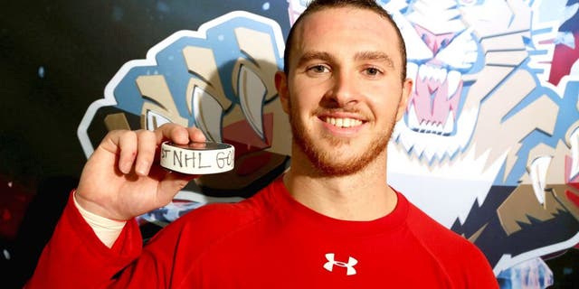 RALEIGH, NC - OCTOBER 13: Connor Brickley #86 of the Florida Panthers poses with the puck after scoring his first NHL goal following a game against the Carolina Hurricanes at PNC Arena on October 13, 2015 in Raleigh, North Carolina. (Photo by Gregg Forwerck/NHLI via Getty Images)