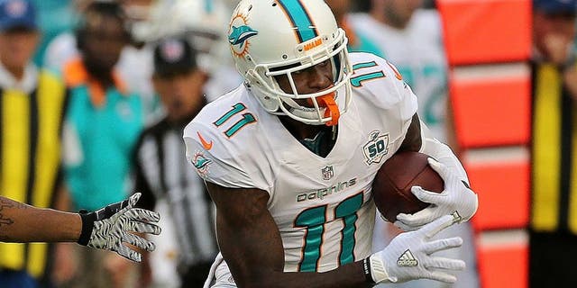 DeVante Parker #11 of the Miami Dolphins is defended by Anthony Dixon #26 of the Buffalo Bills during a game at Sun Life Stadium on September 27, 2015 in Miami Gardens, Florida. 