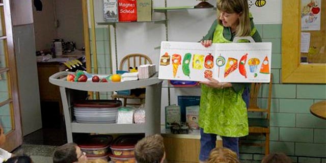 Sept. 20,: Nancy Henderson, home economic coordinator for the fresh fruit and vegetables program, works with the students at Northeast Elementary Magnet, in Danville, Ill.