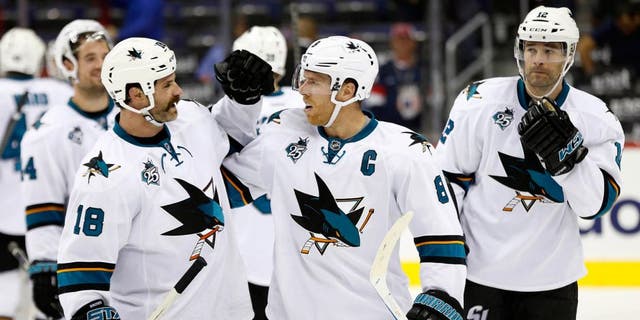 Oct 13, 2015; Washington, DC, USA; San Jose Sharks right wing Mike Brown (18) celebrates with Sharks center Joe Pavelski (8) after their game against the Washington Capitals at Verizon Center. The Sharks won 5-0. Mandatory Credit: Geoff Burke-USA TODAY Sports