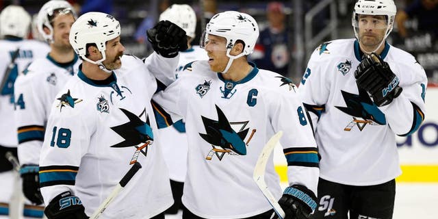 Oct 13, 2015; Washington, DC, USA; San Jose Sharks right wing Mike Brown (18) celebrates with Sharks center Joe Pavelski (8) after their game against the Washington Capitals at Verizon Center. The Sharks won 5-0. Mandatory Credit: Geoff Burke-USA TODAY Sports