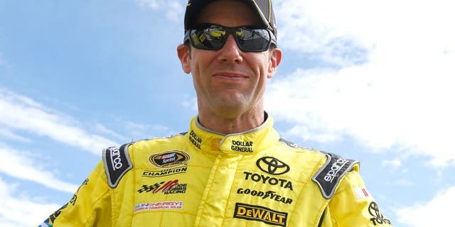 Matt Kenseth, driver of the #20 Dollar General Toyota, stands on the grid during qualifying for the NASCAR Sprint Cup Series Axalta "We Paint Winners" 400 at Pocono Raceway on June 5, 2015 in Long Pond, Pennsylvania.