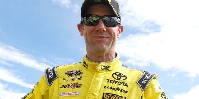 Matt Kenseth, driver of the #20 Dollar General Toyota, stands on the grid during qualifying for the NASCAR Sprint Cup Series Axalta "We Paint Winners" 400 at Pocono Raceway on June 5, 2015 in Long Pond, Pennsylvania.