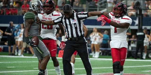 Oct 3, 2015; Arlington, TX, USA; Baylor Bears wide receiver Corey Coleman (1) and Texas Tech Red Raiders defensive back Jah'Shawn Johnson (7) are separated by back judge Lyndon Nixon after Coleman scores a touchdown during the first quarter at AT&amp;T Stadium. Mandatory Credit: Jerome Miron-USA TODAY Sports