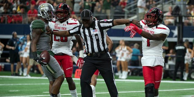 Oct 3, 2015; Arlington, TX, USA; Baylor Bears wide receiver Corey Coleman (1) and Texas Tech Red Raiders defensive back Jah'Shawn Johnson (7) are separated by back judge Lyndon Nixon after Coleman scores a touchdown during the first quarter at AT&T Stadium. Mandatory Credit: Jerome Miron-USA TODAY Sports
