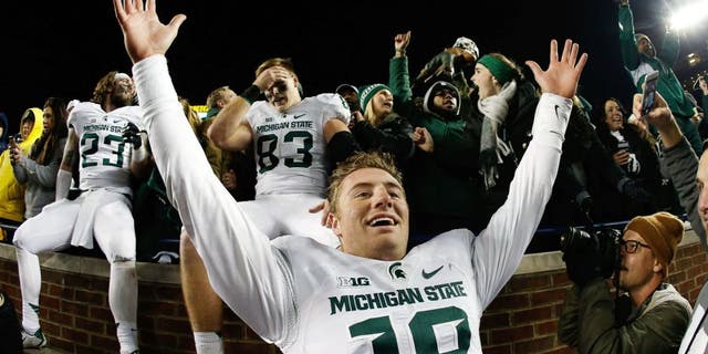 ANN ARBOR, MI - OCTOBER 17: Quarterback Connor Cook #18 of the Michigan State Spartans celebrates after defeating the Michigan Wolverines 27-23 in the college football game at Michigan Stadium on October 17, 2015 in Ann Arbor, Michigan. (Photo by Christian Petersen/Getty Images)