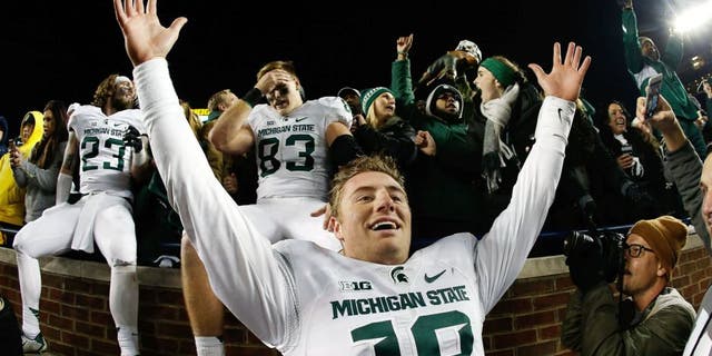 ANN ARBOR, MI - OCTOBER 17: Quarterback Connor Cook #18 of the Michigan State Spartans celebrates after defeating the Michigan Wolverines 27-23 in the college football game at Michigan Stadium on October 17, 2015 in Ann Arbor, Michigan. (Photo by Christian Petersen/Getty Images)