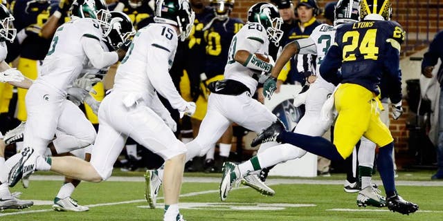 Michigan State defensive back Jalen Watts-Jackson (20) runs towards the end zone after recovering a fumbled snap on a punt in the closing seconds of the second half of an NCAA college football game, Saturday, Oct. 17, 2015, in Ann Arbor, Mich. Watts-Jackson lumbered 38 yards for a touchdown on the final play of the game, giving No. 7 Michigan State a shocking 27-23 win over No. 12 Michigan(AP Photo/Carlos Osorio)