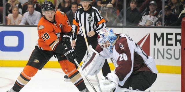 October 16, 2015; Anaheim, CA, USA; Anaheim Ducks right wing Corey Perry (10) shoots against Colorado Avalanche goalie Reto Berra (20) during the second period at Honda Center. Mandatory Credit: Gary A. Vasquez-USA TODAY Sports