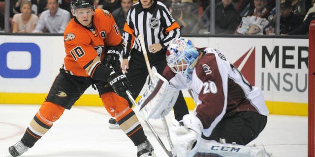 October 16, 2015; Anaheim, CA, USA; Anaheim Ducks right wing Corey Perry (10) shoots against Colorado Avalanche goalie Reto Berra (20) during the second period at Honda Center. Mandatory Credit: Gary A. Vasquez-USA TODAY Sports