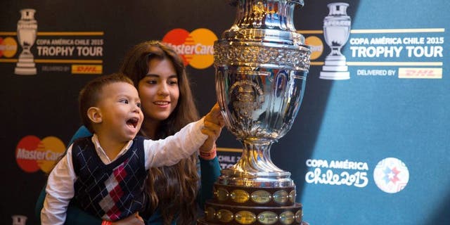 MEXICO CITY, MEXICO - MAY 21: A child touches the Copa America's Trophy during the Copa America Trophy Tour at Papalote Museo del Niâ±o in Mexico City, Mexico on May 21, 2015. Copa America Tournament will be held in Chile from 11 June to 4 July. (Photo by Daniel Cardenas/Anadolu Agency/Getty Images)